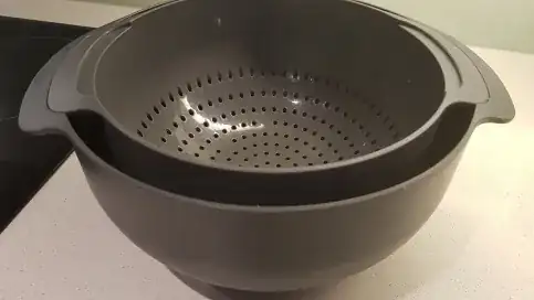 Colander suspended in bowl
