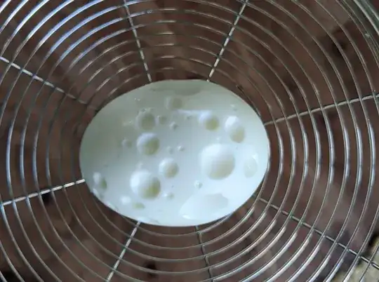 photo of peeled boiled egg with a bunch of perfectly round craters