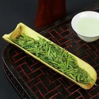 Image of longjing green tea leaves, bright and compressed