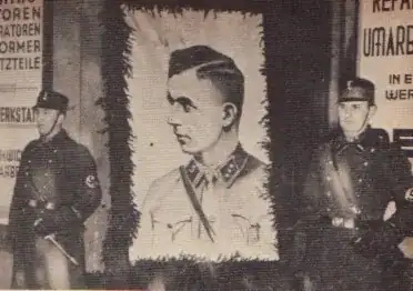 Uniformed SA members stand as an Honor Guard alongside a portrait of Horst Wessel.