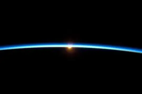 black photo with thin blue arc of the atmosphere