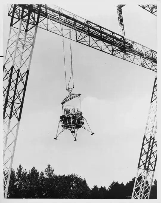 mock lunar lander held aloft by a hoist
