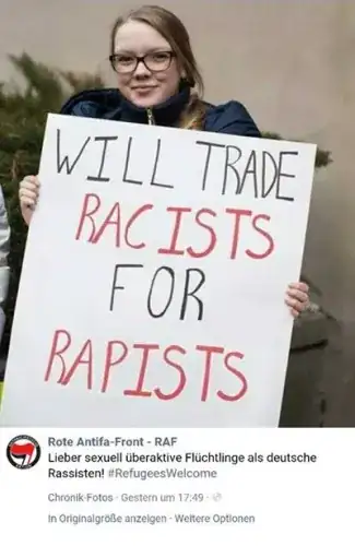 Woman carrying sign "Will trade racists for rapists"