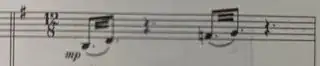 photograph of score: bar of 12, with two tremolo figures separated by dotted crotchet rests, each figure represented as pairs of quavers with two extra truncated beams